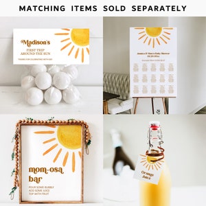 K&ouml;nnte beinhalten: Ein Set an Babyparty-Dekorationen mit einem Sonnenmotiv. Die Dekorationen beinhalten ein Schild mit der Aufschrift "mom-osa bar", ein Schild mit der Aufschrift "Madison's First Trip Around the Sun", einen Sitzplan und eine Flasche Orangensaft mit einem Etikett mit der Aufschrift "Orange Juice".