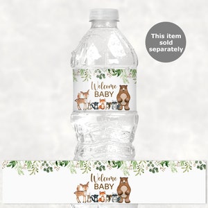 May include: Water bottle label with a woodland theme. The label features a brown bear, a deer, a fox, a raccoon, and a squirrel. The text on the label reads "Welcome Baby".