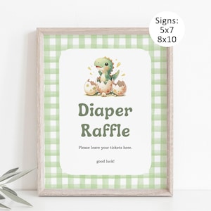 May include: A framed sign with a green gingham border and a white centre. The centre features a watercolour illustration of a baby dinosaur hatching from an egg. Text reads "Diaper Raffle" and "Please leave your tickets here. good luck!" Sizes: 5x7 and 8x10.