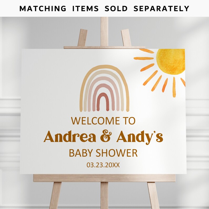 May include: Welcome to Andrea & Andy's Baby Shower sign with a rainbow and sun illustration. The sign is white with brown text and a date of 03.23.20XX.