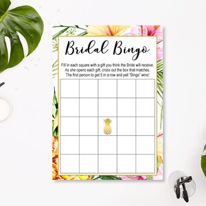 May include: A printable bridal shower bingo card with a tropical theme. The card has a floral border and a pineapple in the center. The text on the card reads "Bridal Bingo" and includes instructions for playing the game.