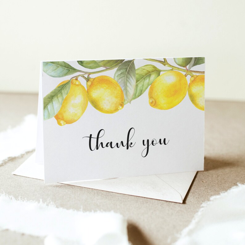 May include: A white thank you card with a border of watercolor lemons and green leaves. The text "thank you" is written in black cursive.