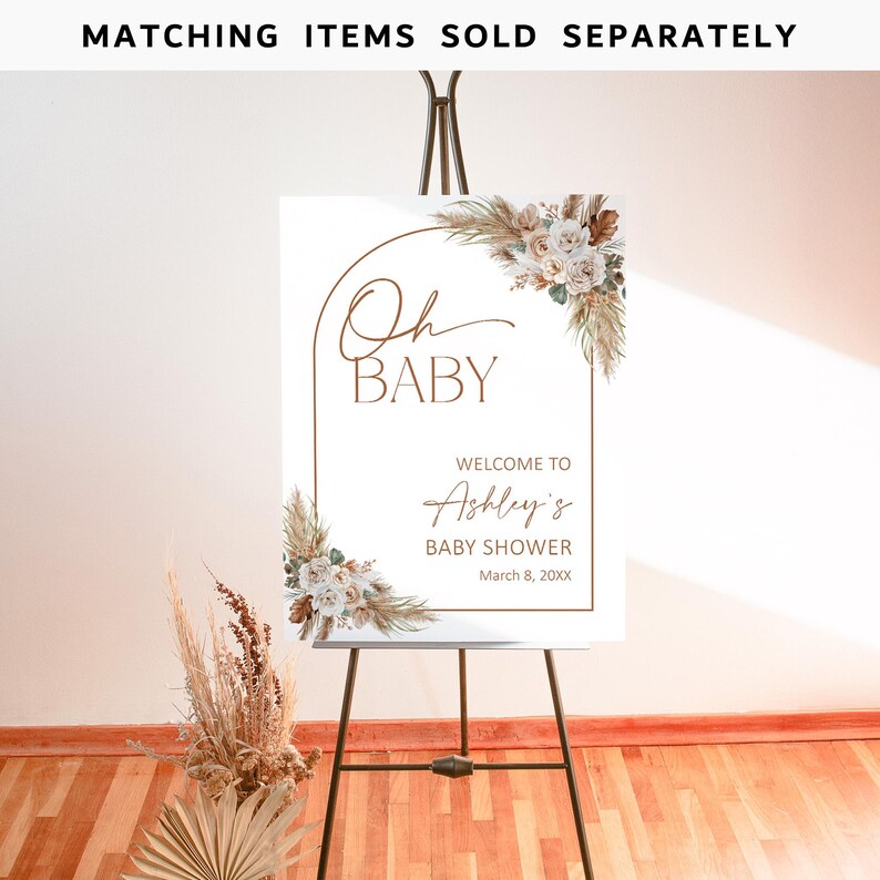 May include: A white welcome sign with a brown archway and floral design. The text reads "Oh Baby" and "Welcome to Ashley's Baby Shower, March 8, 20XX".