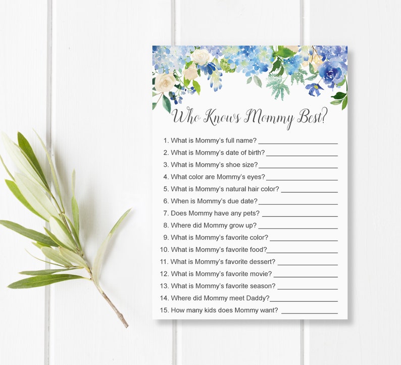 May include: A baby shower game card titled "Who Knows Mommy Best?" features a floral design with blue and white flowers. The card includes fill-in-the-blank questions about the mother-to-be, such as her favorite color and movie.