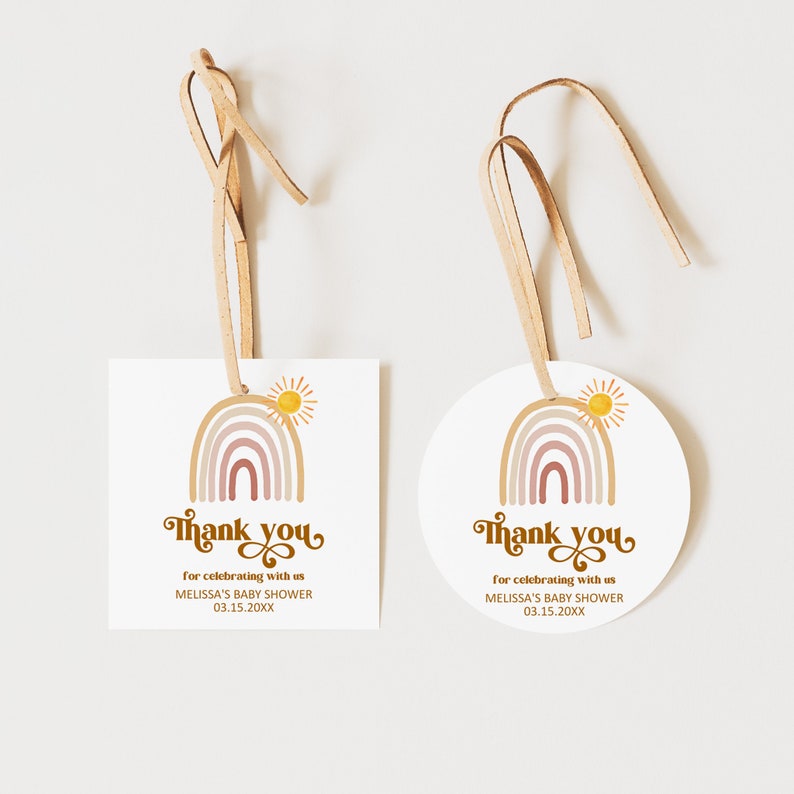May include: Two thank you tags with a rainbow and sun design. The tags are both white with brown text that reads 'Thank you for celebrating with us Melissa's Baby Shower 03.15.20XX'. One tag is square and the other is round. Both tags have a brown string attached.