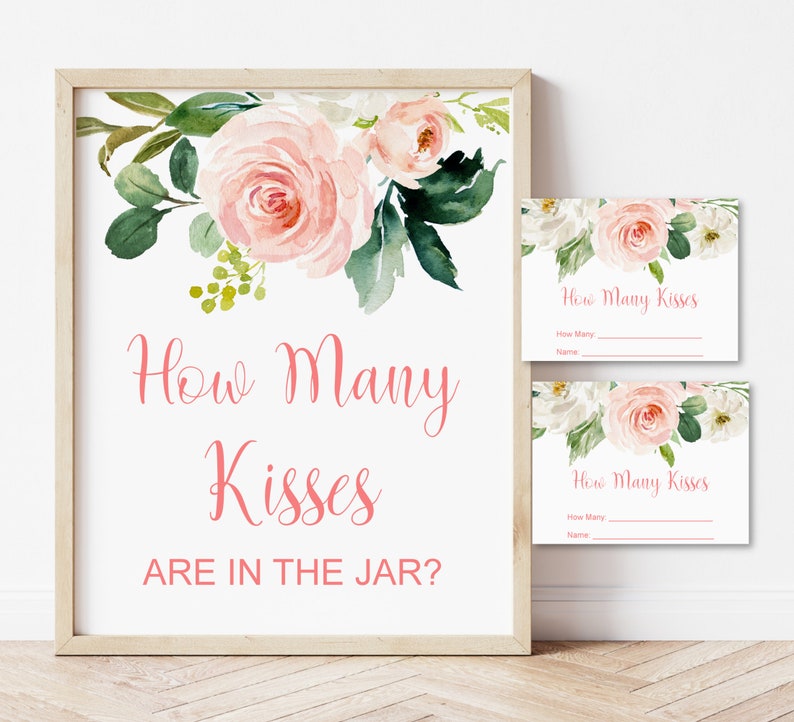 May include: A printable sign with pink floral designs and the text "How Many Kisses Are In The Jar?" with two matching smaller cards that say "How Many Kisses" with lines for guests to write their guesses and names.