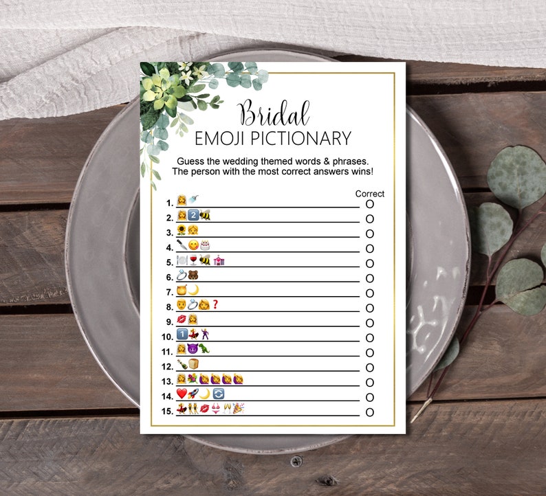 May include: A printable bridal shower game with a green floral design. The game is called "Bridal Emoji Pictionary" and asks players to guess wedding themed words and phrases represented by emojis. The game includes 15 questions with a space for players to mark their answers.