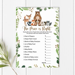 May include: A printable game card with a woodland theme. The card has a title that says "The Price is Right" and a list of baby items with blank spaces to fill in the price. The card is decorated with watercolor illustrations of woodland animals, including a bear, a fox, a deer, a raccoon, and an owl.