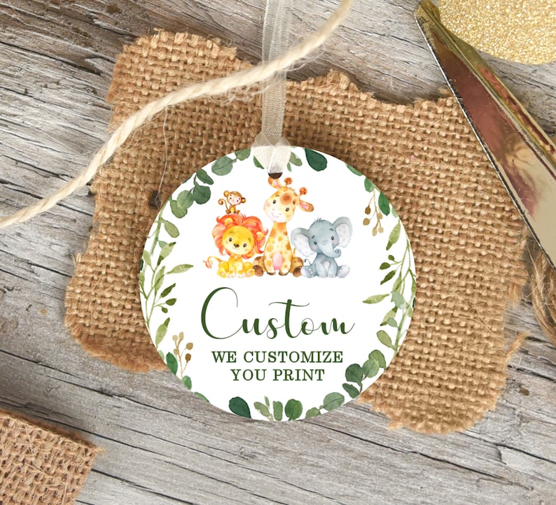 May include: A round, white tag with a green leafy border. The tag features a lion, giraffe, and elephant with the text "Custom We Customize You Print".