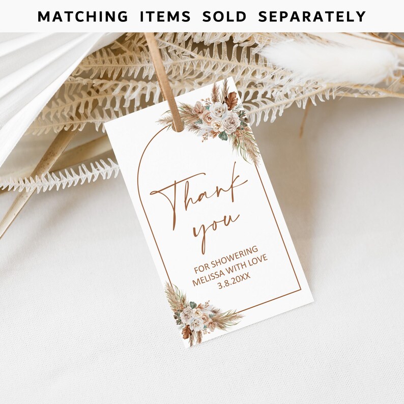 May include: A white thank you tag with a brown arch and floral design. The text reads "Thank you for showering Melissa with love 3.8.20XX".