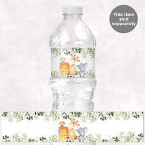 May include: Water bottle label with a jungle theme. The label features a lion, giraffe, and elephant with green foliage around them. The label is white with a green border.