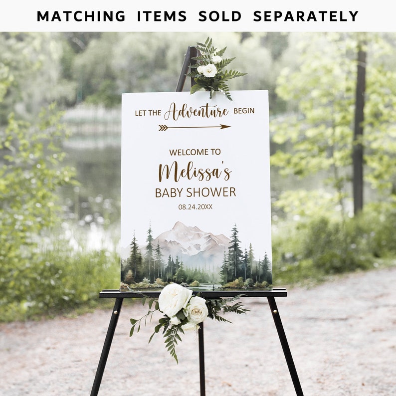 Pode incluir: Uma placa branca com uma cena de montanha em aquarela e o texto "Let the Adventure Begin" com uma seta apontando para a direita. O texto "Welcome to Melissa's Baby Shower" e a data "08.24.20XX" est&atilde;o abaixo da seta. A placa est&aacute; em um cavalete preto.