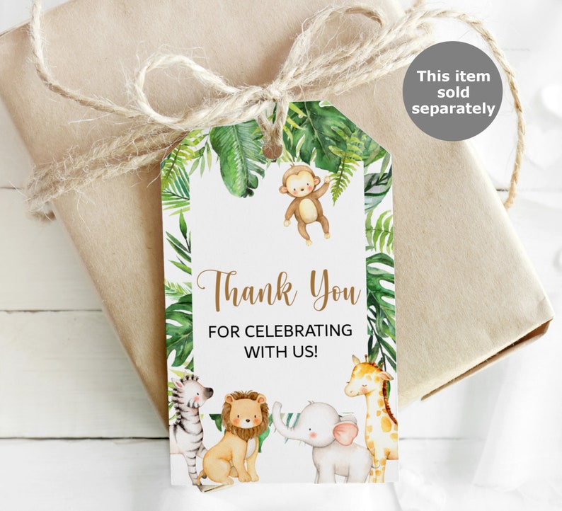 May include: A white thank you tag with a jungle theme. The tag features a monkey, zebra, lion, elephant, and giraffe. The text on the tag reads "Thank You for Celebrating with Us!"