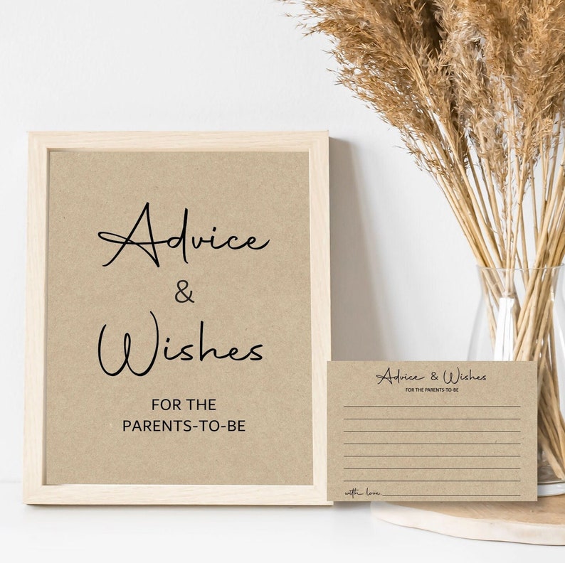 May include: A framed sign with the text "Advice & Wishes for the Parents-to-Be" on a brown background. A smaller card with the same text is below the sign, with lines for writing.