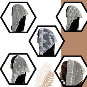 May include: A collection of white lace veils, each with a unique floral or dotted pattern. The veils are draped over mannequin heads, showcasing the delicate designs and textures. The background is a mix of white and brown.