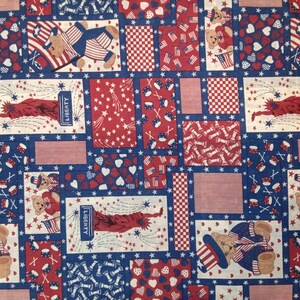 May include: Red, white, and blue fabric with a patchwork design featuring stars, hearts, and American flags. The fabric also features images of teddy bears wearing patriotic hats and holding drums. The text "LIBERTY" appears on the fabric.