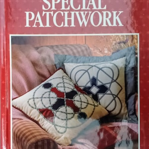 May include: A book titled "Special Patchwork" by Better Homes and Gardens, featuring a close-up of two decorative pillows with intricate rope-like designs in shades of red, blue, and white.