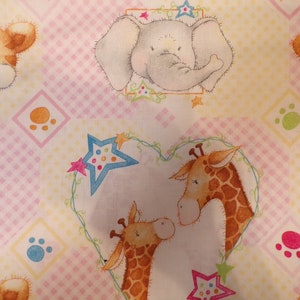 May include: A pink and yellow fabric with a repeating pattern of animals and stars. The animals include a tiger, an elephant, and two giraffes. The stars are blue, pink, and green.