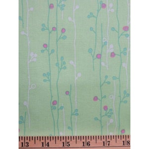 May include: Green fabric with a white and light blue floral pattern. The fabric has a repeating pattern of small flowers and stems.