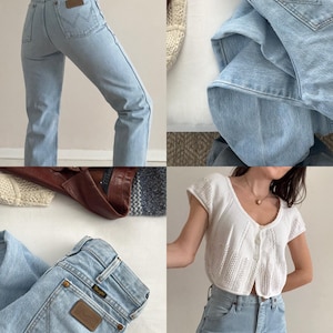 May include: Light blue denim jeans with a brown leather patch on the back pocket. The jeans are paired with a white, short-sleeved, button-up top. The image showcases a vintage clothing aesthetic.