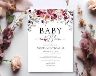 May include: A baby shower invitation with a floral design in shades of pink, red, and white. The text reads "Baby in Bloom" and includes the date, time, and location of the event. RSVP to Joanna at 123-456-7890. Registered at www.babylist.com.