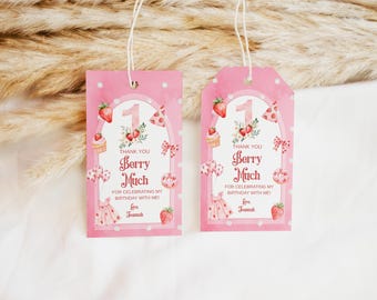 May include: Two pink gift tags with a strawberry theme. Each tag features the text "Thank You Berry Much" and "For Celebrating My Birthday With Me!" along with illustrations of strawberries, cupcakes, and bows. The tags are connected to white string.