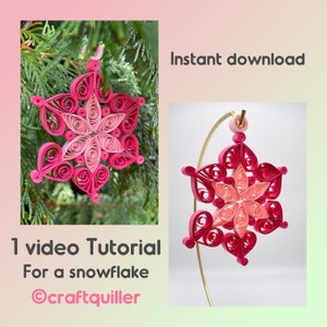May include: A pink and red paper snowflake ornament with intricate details. The snowflake is hanging from a gold wire. The image includes the text "Instant download" and "1 video Tutorial For a snowflake @craftquiller".