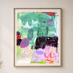 May include: Abstract art print in a wooden frame. The artwork features a vibrant mix of colors, including green, purple, pink, and black, with brushstrokes creating a textured effect. The piece is a modern, colorful addition to any space.