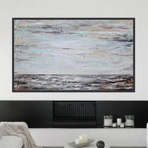 May include: Abstract painting of a seascape with a light blue sky and gray and brown waves. The painting is framed in a black frame.