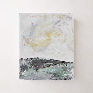 May include: Abstract painting with a white background and a light yellow and gray cloud-like shape in the upper portion. The lower portion of the painting is a dark gray and green landscape.