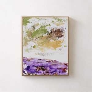 May include: Abstract painting with a gold frame. The painting features a purple and brown landscape at the bottom and a green and brown abstract design at the top.