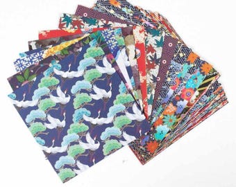 May include: A fan of colourful origami paper with various patterns, including cranes, flowers, and geometric designs. The paper is folded in a fan shape, revealing a variety of colours and patterns.
