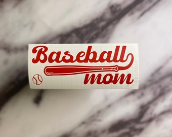 May include: Red vinyl decal with the text "Baseball mom" in a retro font. A red baseball bat and a white baseball are included in the design.