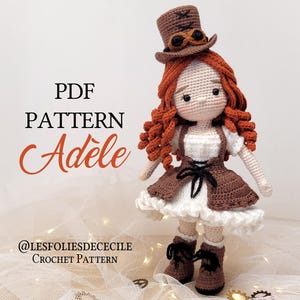 May include: A handmade crochet doll named Adele, wearing a brown steampunk-style outfit with a matching hat and boots. The doll has red curly hair and a white dress. The image includes the text "PDF PATTERN Adele" and the Etsy shop's name.