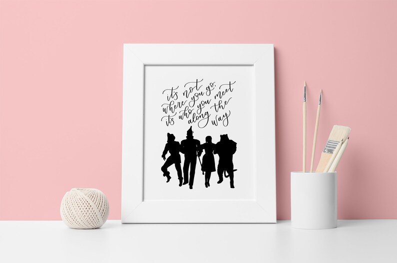 May include: Black and white silhouette print of the Wizard of Oz characters with the quote "It's not where you go, it's who you meet along the way."