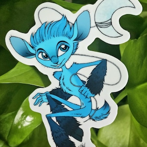 May include: A sticker featuring a blue cartoon creature with large ears, a crescent moon, and dark blue fur accents. The creature is smiling and holding a string attached to the moon. The sticker has the text "@riverside.studios.co" at the top.