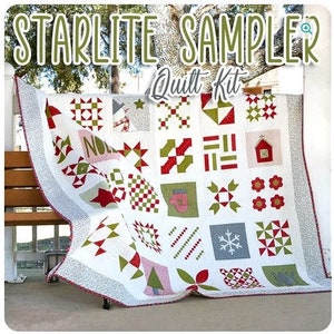 Könnte beinhalten: Ein weißer Quilt-Kit mit einem roten, grünen und weißen Weihnachtsmuster. Der Quilt ist gefaltet und auf einer Holzbank ausgestellt. Der Quilt ist mit "Starlite Sampler Quilt Kit" beschriftet.