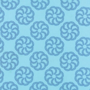 May include: A seamless pattern of blue floral designs on a light blue background. The floral designs are circular and have a swirling pattern.