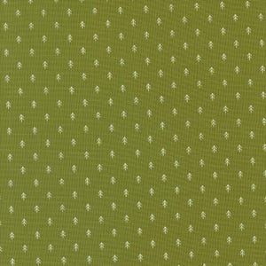 May include: Green fabric with a repeating pattern of small white tree shapes. The trees are evenly spaced across the fabric, creating a consistent and natural design. The fabric has a textured appearance.