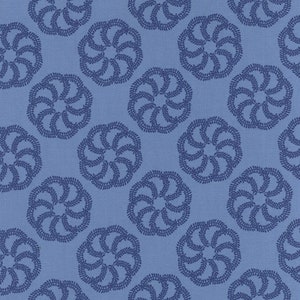 May include: A blue and white fabric with a repeating pattern of stylised floral designs. The fabric has a textured surface.