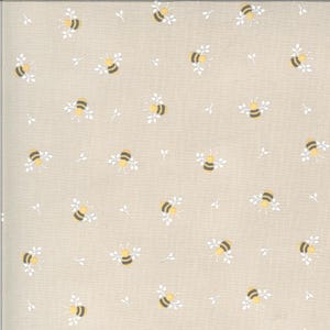 May include: Beige fabric with a repeating pattern of yellow and black bees, along with small white leaf sprigs. The bees have black stripes and yellow bodies. The fabric has a subtle, textured appearance.