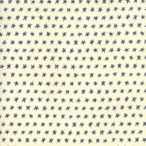 May include: Cream-colored fabric with a repeating pattern of navy blue star-like shapes. The stars are hand-drawn with a cross-like design, creating a textured and whimsical appearance. This fabric is suitable for various sewing and crafting projects.