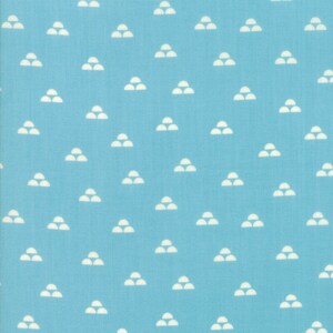 May include: A blue fabric with a white repeating pattern of three half circles stacked on top of each other.