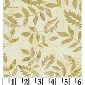 May include: A beige fabric with a repeating pattern of gold leaf silhouettes. The fabric is measured in inches.