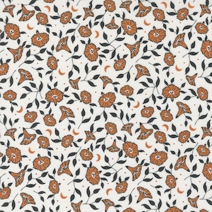 May include: A white fabric with a repeating pattern of orange flowers, crescent moons, and black stems.