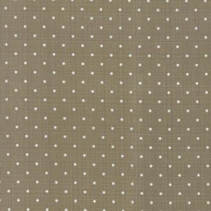 May include: A tan fabric with a subtle woven texture, featuring a repeating pattern of small, evenly spaced white polka dots. The dots are consistent in size, creating a classic, playful design.