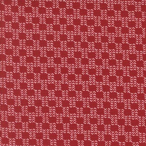 May include: A close-up of red fabric featuring a repeating pattern of white arrow-shaped motifs. The design creates a textured effect, suitable for various textile applications.