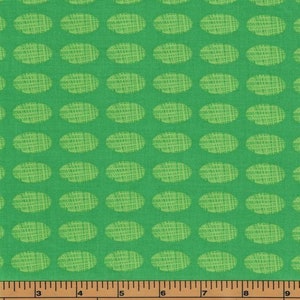 May include: Green fabric with a repeating pattern of light green oval shapes. The ovals have a textured, woven look.