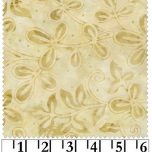 May include: A beige fabric with a light brown floral pattern. The fabric is 6 inches wide.