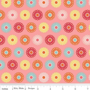 May include: A pink fabric with a repeating pattern of colorful flowers. The flowers are in shades of red, orange, yellow, blue, and white. The fabric is perfect for quilting, crafts, and home decor.